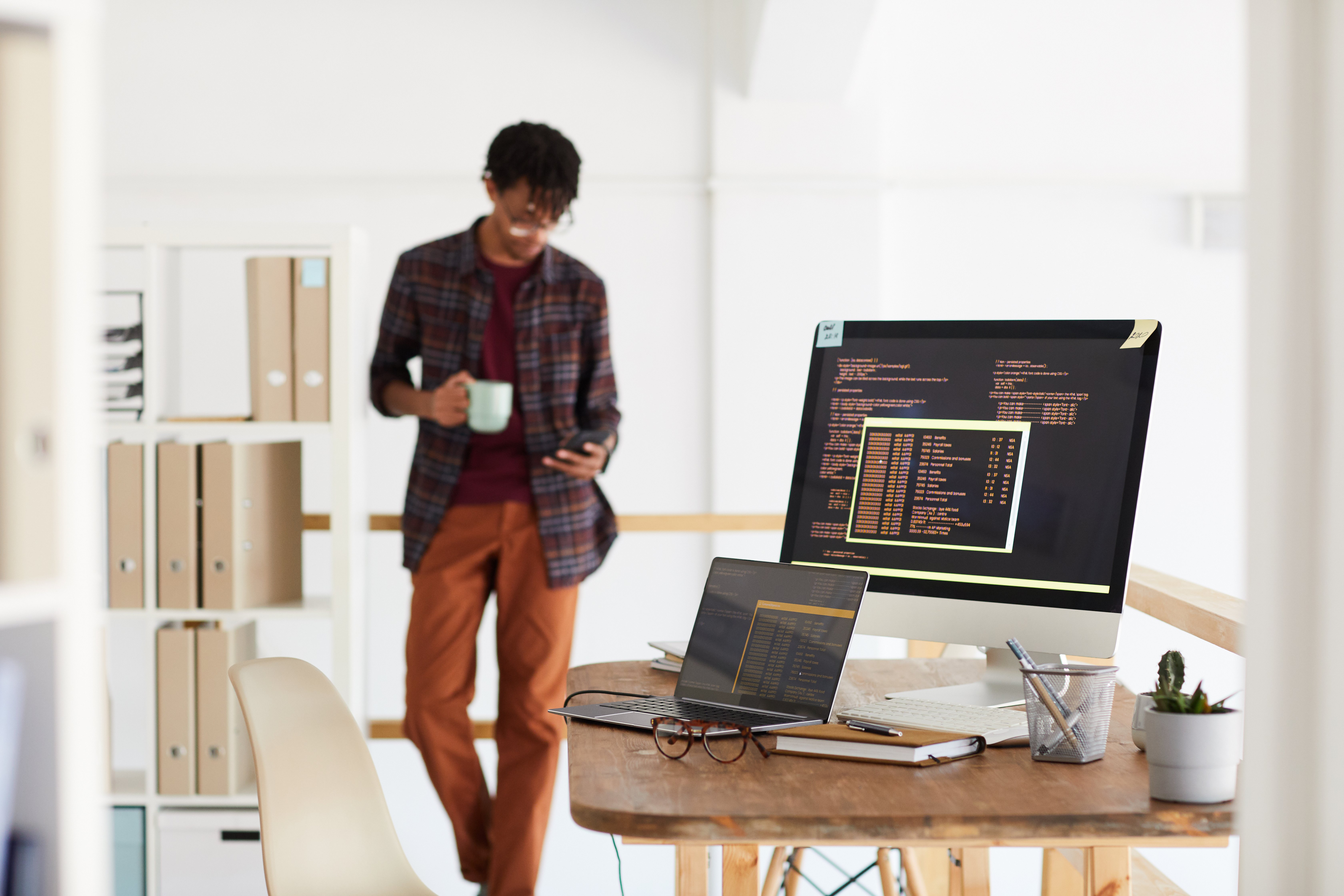 background-image-of-programming-code-on-computer-screen-in-modern-office-interior-with-blurred-shape-of-african-american-man-copy-space background-image-of-programming-code-on-computer-screen-in-modern-office-interior-with-blurred-shape-of-african-american-man-copy-space