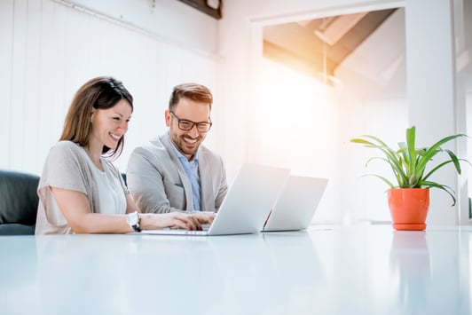 business-couple-working-together-on-project-at-modern-startup-office